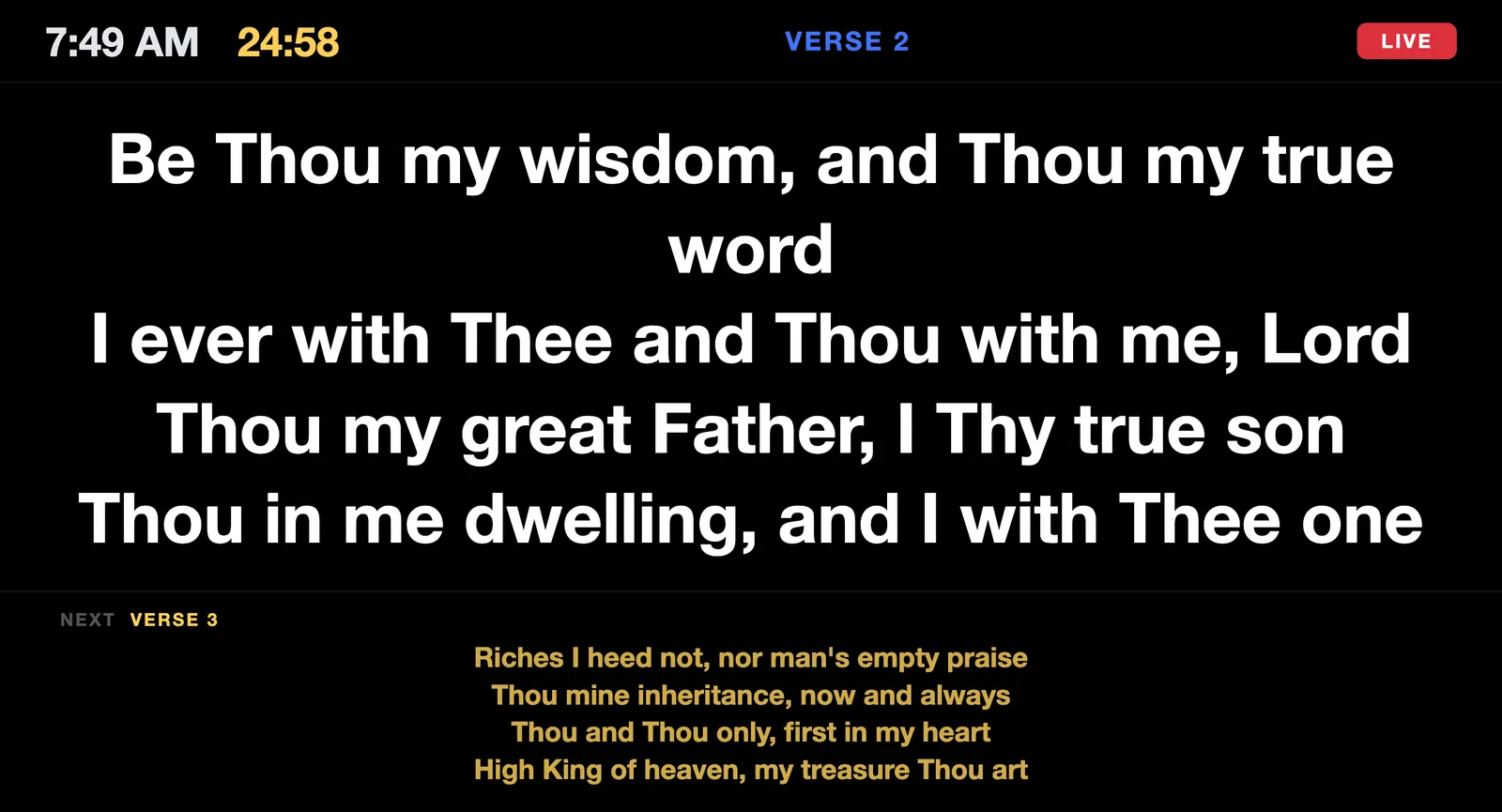 Stage display on black: the clock and a yellow 24:58 countdown at the top left, Verse 2 and a red LIVE badge across the top, the current verse in very large white text, and the next verse previewed in yellow below.
